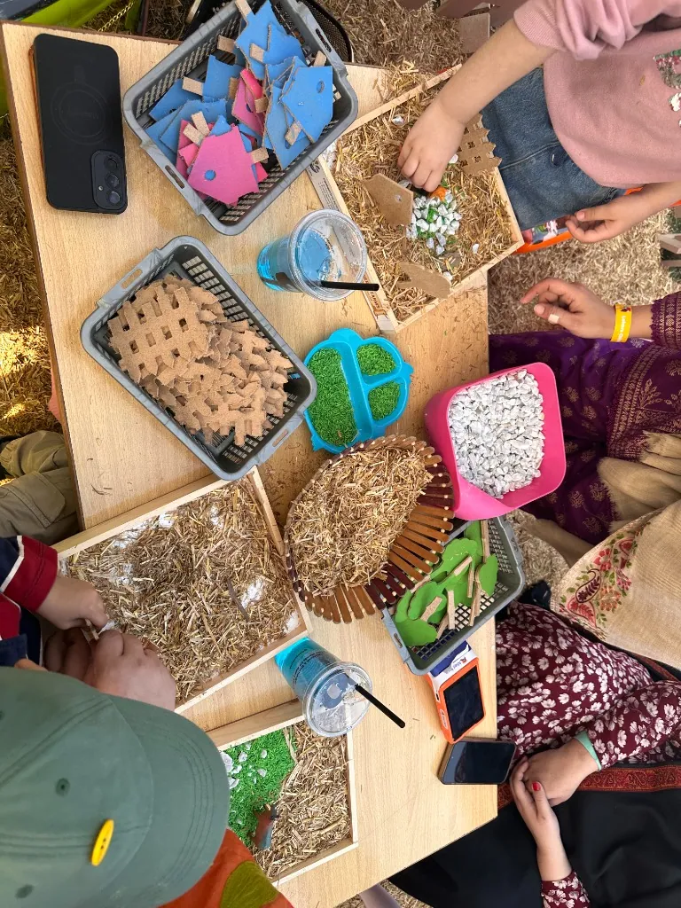 Sensory play trays filled with straw, grain and natural materials