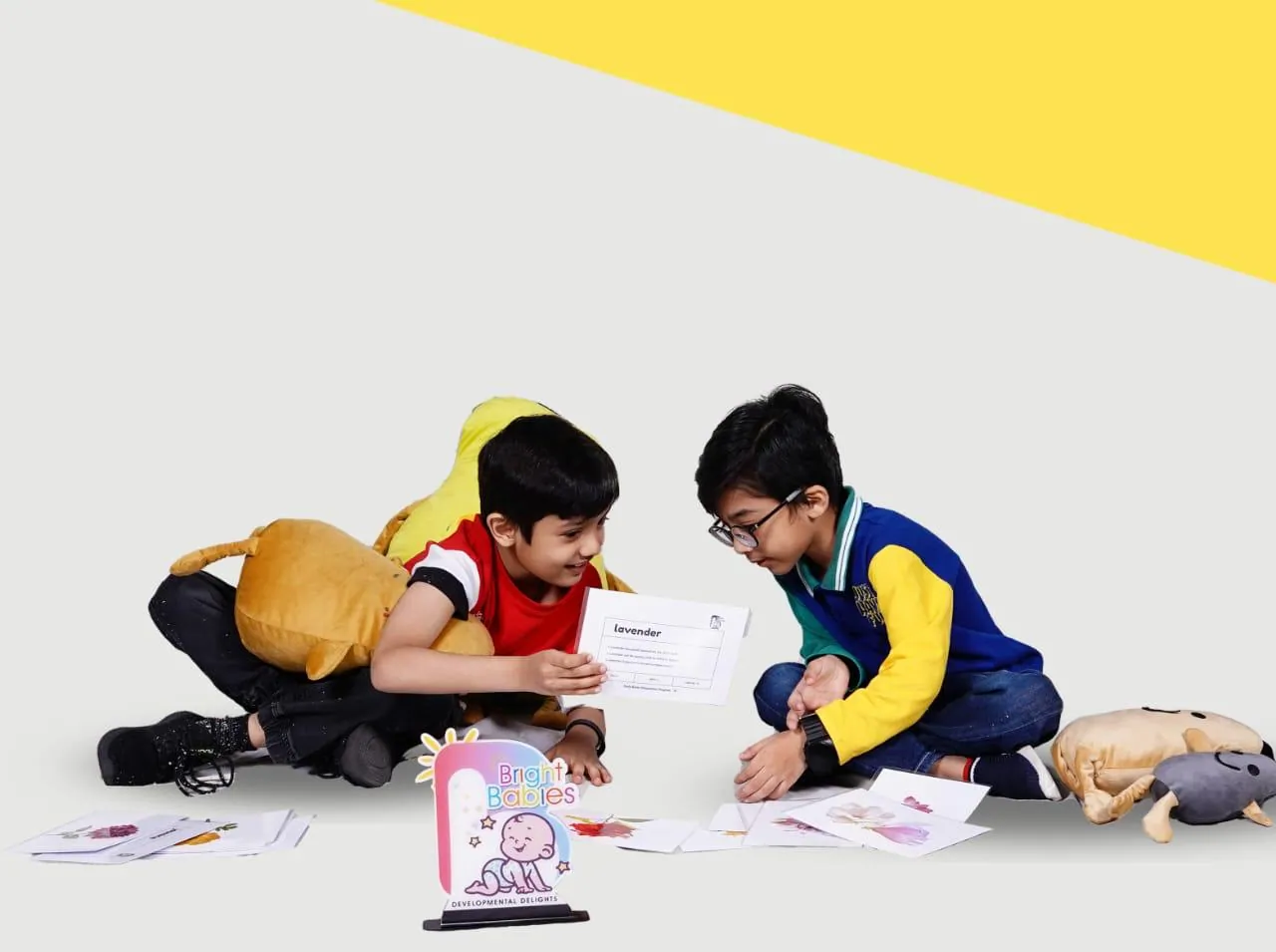 Two boys playing a word card game on the floor